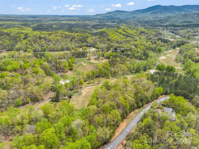 a view of a yard with wooden fence