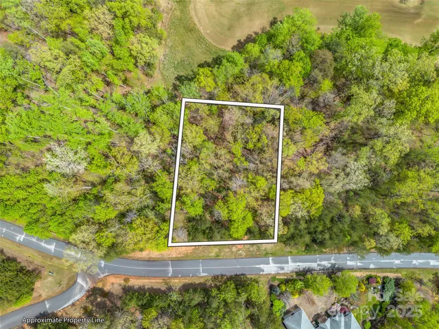a view of a yard with wooden fence