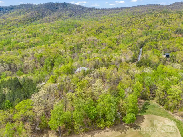 a view of a field with an ocean view