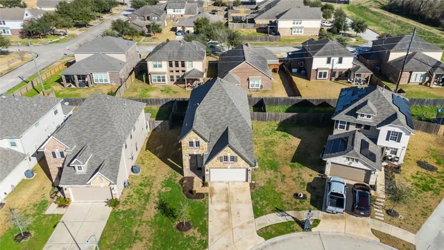 an aerial view of a house with garden space and ocean view