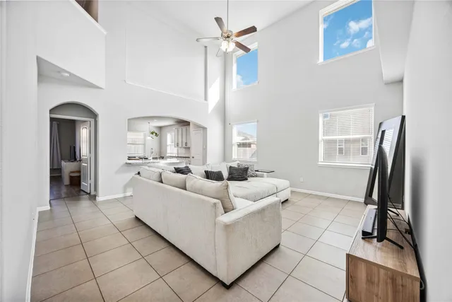 a living room with furniture a flat screen tv and a window