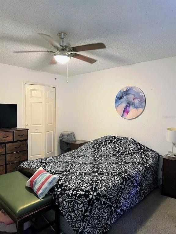 2214 Metropolitan Way, Unit 2210 Orlando, FL 32839 - Photo 7 of 14 a bedroom with a bed and a flat screen tv