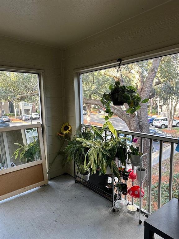 2214 Metropolitan Way, Unit 2210 Orlando, FL 32839 - Photo 8 of 14 a view of a porch with furniture and garden