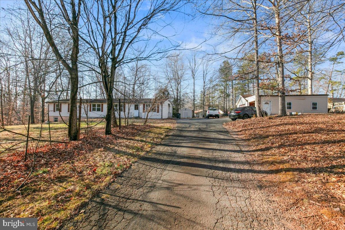 9442 Brentsville Road Manassas, VA 20112 - Photo 2 of 34 Serene driveway leading to a charming home.