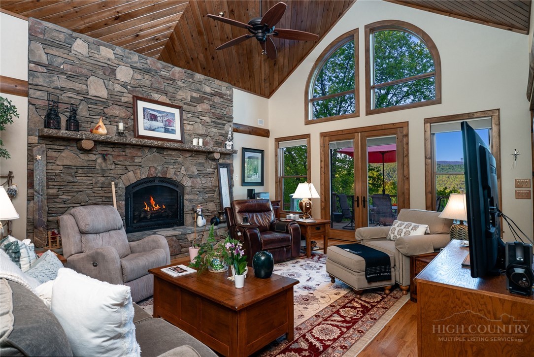 171 Camp Davis Road Banner Elk, NC 28604 - Photo 5 of 48 a living room with furniture fireplace and a large window
