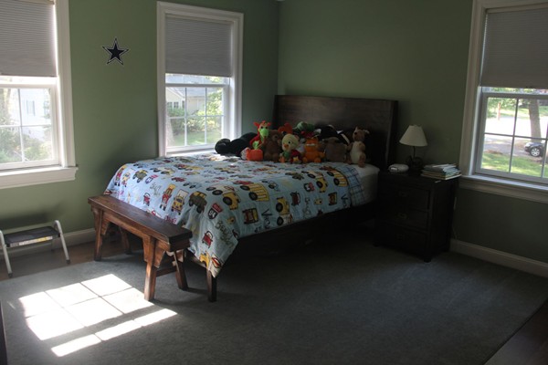 36 Rae Avenue Needham, MA 02492 - Photo 7 of 12 a bed sitting in a bedroom next to a window