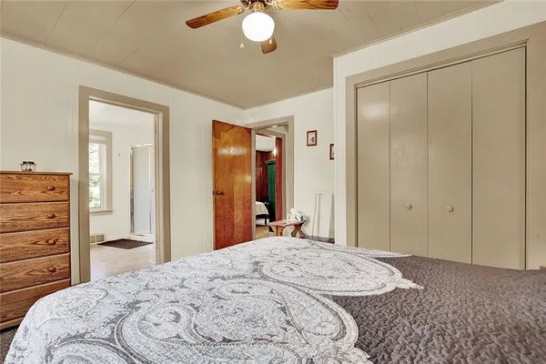 a bedroom with a bed and a dresser