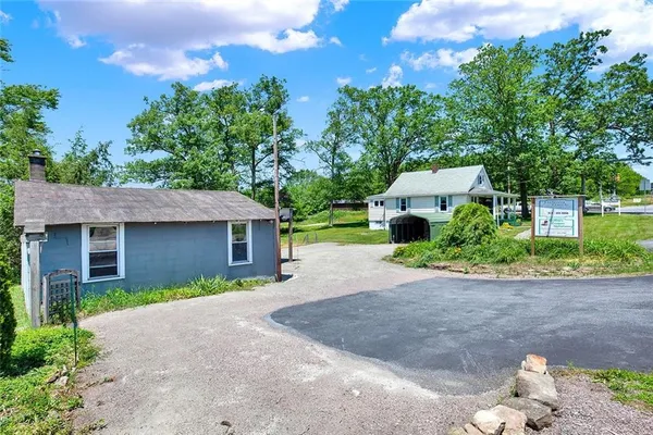 a front view of a house with a yard and a garage