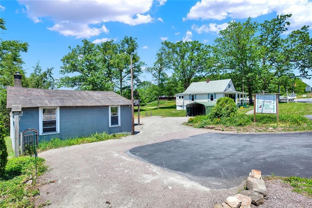 575 Stoystown Road Somerset, PA 15501 - Photo 17 of 26 a front view of a house with a yard and a garage