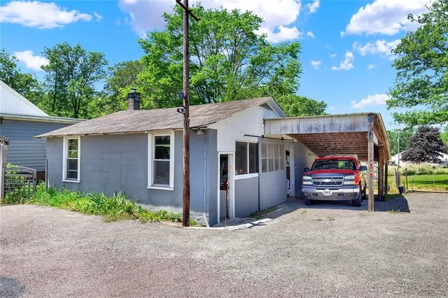 front view of a house with a car parked in it