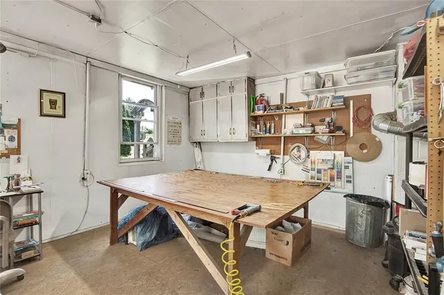 a room with gym equipment and a table