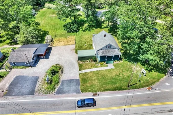an aerial view of a house with a yard and potted plants