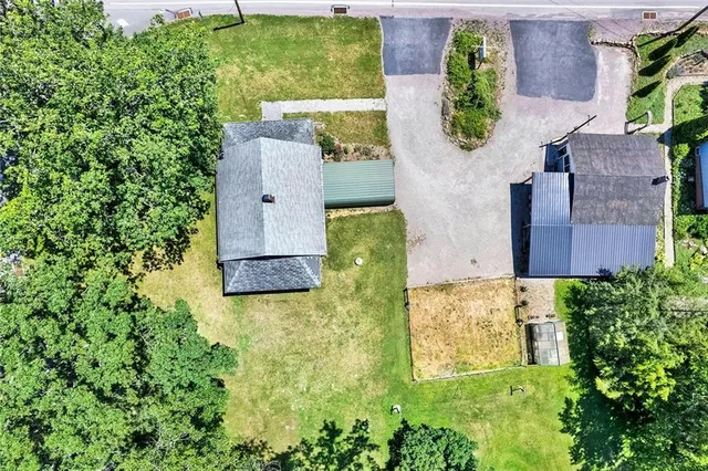 an aerial view of residential house with outdoor space and swimming pool
