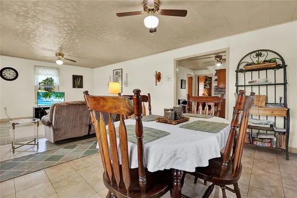a view of a dining room with furniture and a chandelier