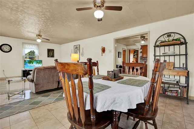 a view of a dining room with furniture and a chandelier
