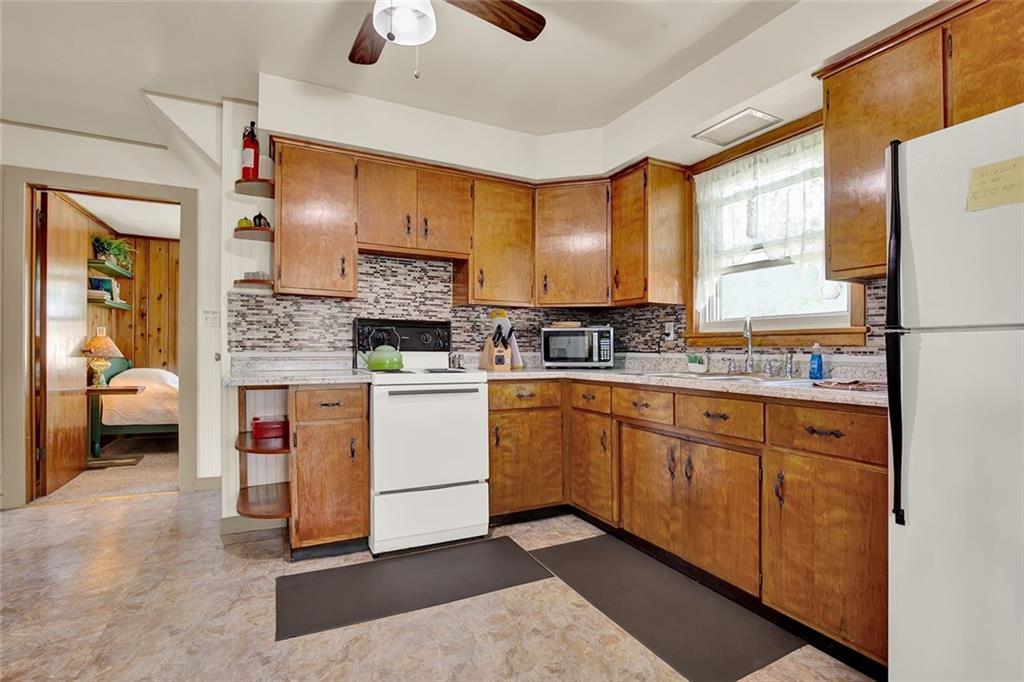 575 Stoystown Road Somerset, PA 15501 - Photo 7 of 26 a kitchen with white cabinets and white appliances