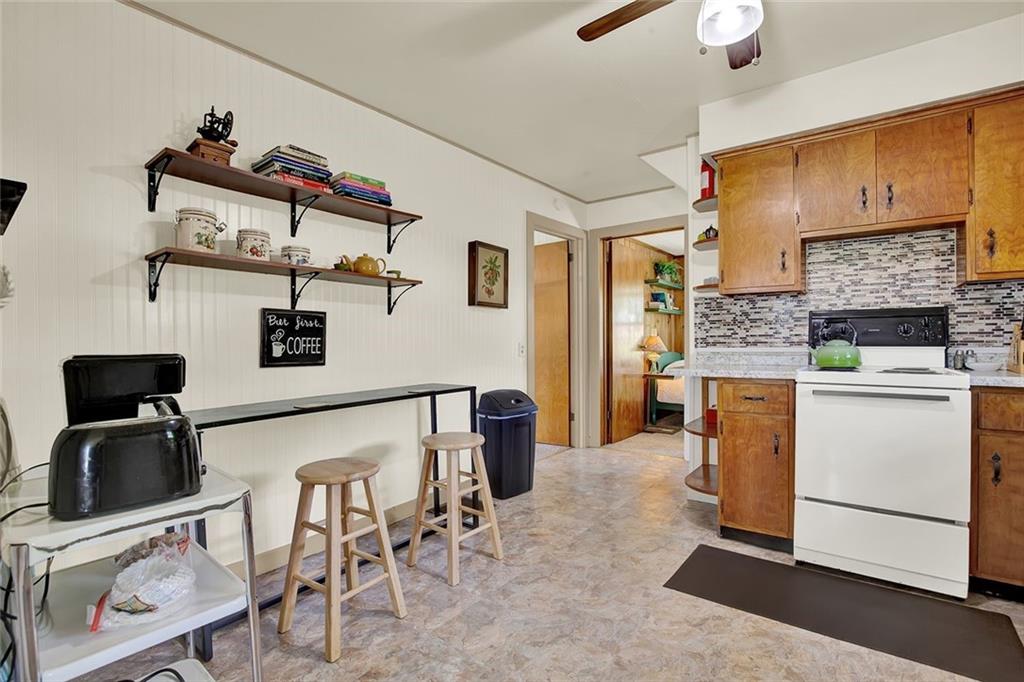 575 Stoystown Road Somerset, PA 15501 - Photo 8 of 26 a kitchen that has a microwave a stove and white cabinets