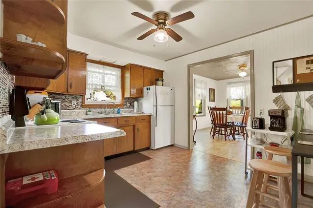 a kitchen with stainless steel appliances granite countertop sink stove top oven and cabinets