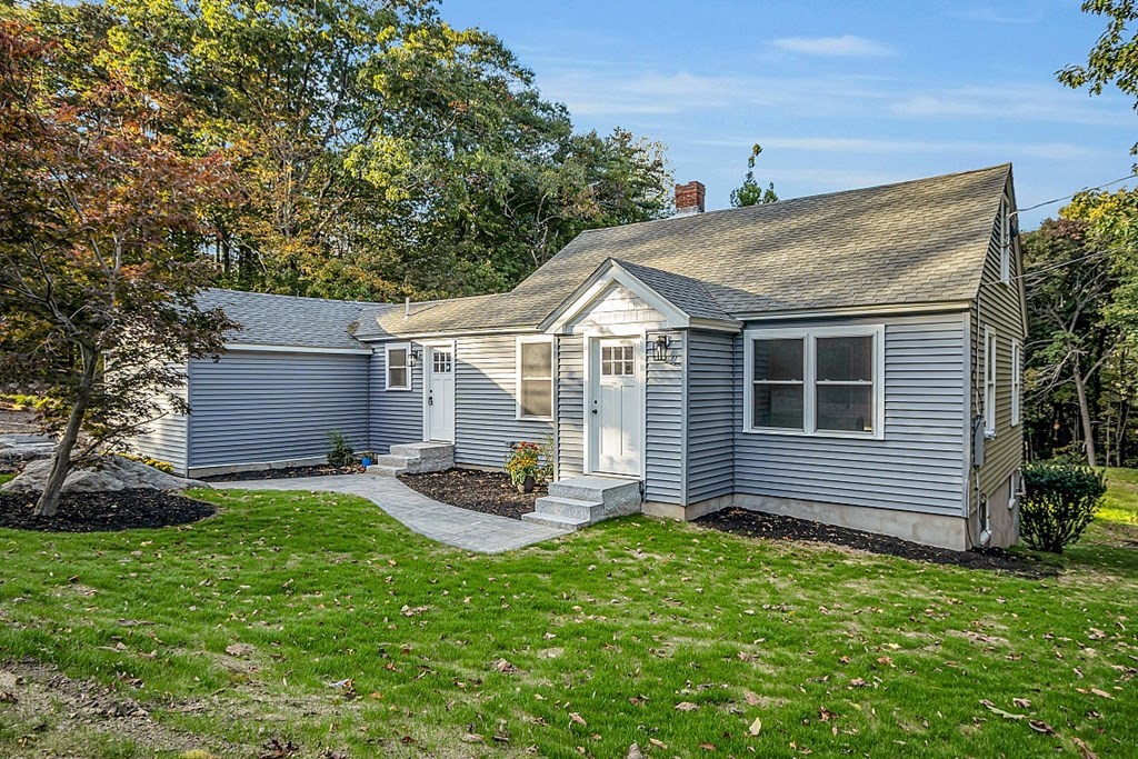 102 Turnpike Road Ashby, MA 01431 - Photo 1 of 40 a front view of a house with a garden