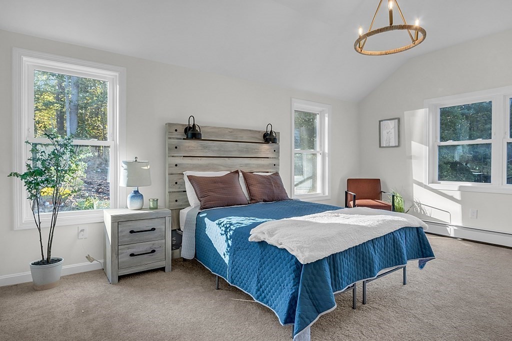 102 Turnpike Road Ashby, MA 01431 - Photo 15 of 40 a bedroom with a bed and a potted plant