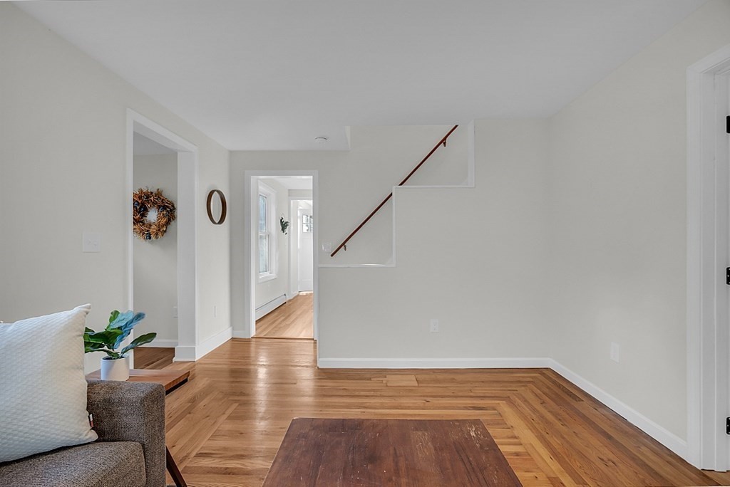 102 Turnpike Road Ashby, MA 01431 - Photo 19 of 40 a view of a livingroom with wooden floor and stairs