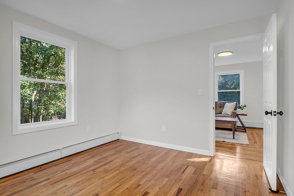 102 Turnpike Road Ashby, MA 01431 - Photo 22 of 40 a view of empty room with wooden floor and fan