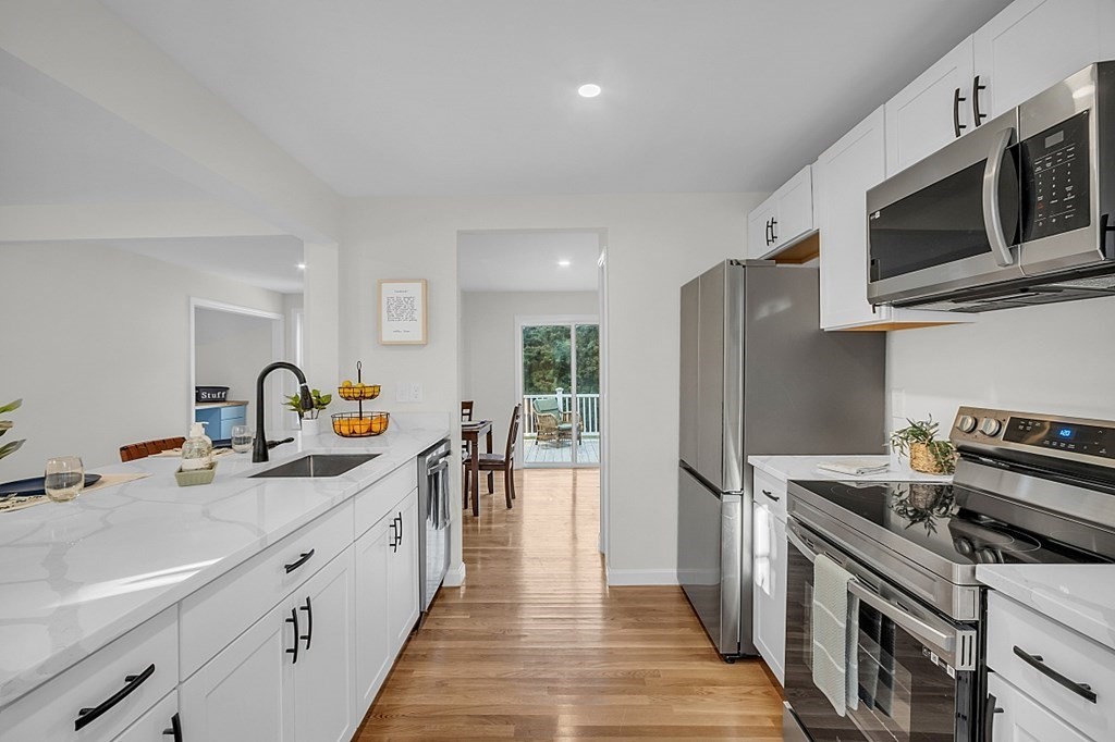 102 Turnpike Road Ashby, MA 01431 - Photo 4 of 40 a kitchen with stainless steel appliances a sink dishwasher a stove and a refrigerator