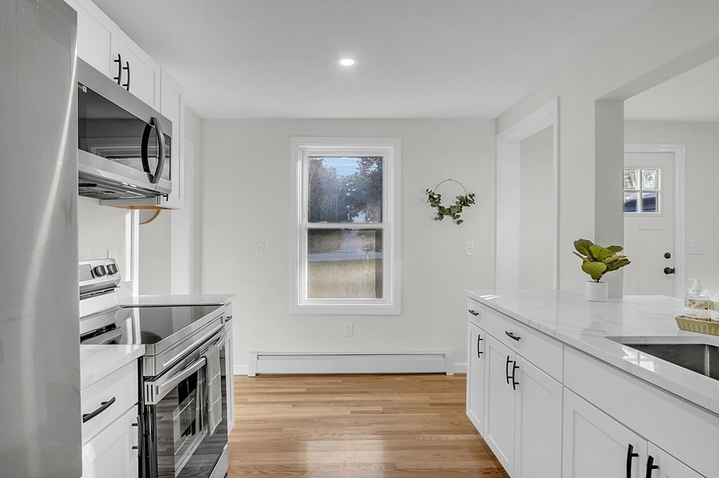 102 Turnpike Road Ashby, MA 01431 - Photo 5 of 40 a kitchen with granite countertop a sink stainless steel appliances and cabinets