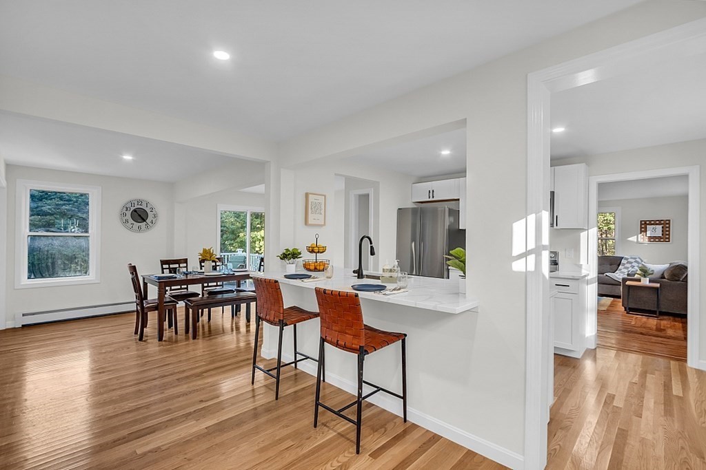 102 Turnpike Road Ashby, MA 01431 - Photo 7 of 40 a view of a dining room with furniture and wooden floor