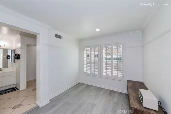 a view of a room with wooden floor and windows