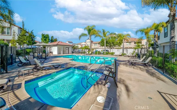 a view of a swimming pool with a patio and a yard