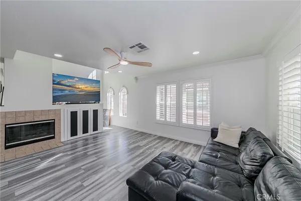 a living room with furniture flat screen tv and a fireplace
