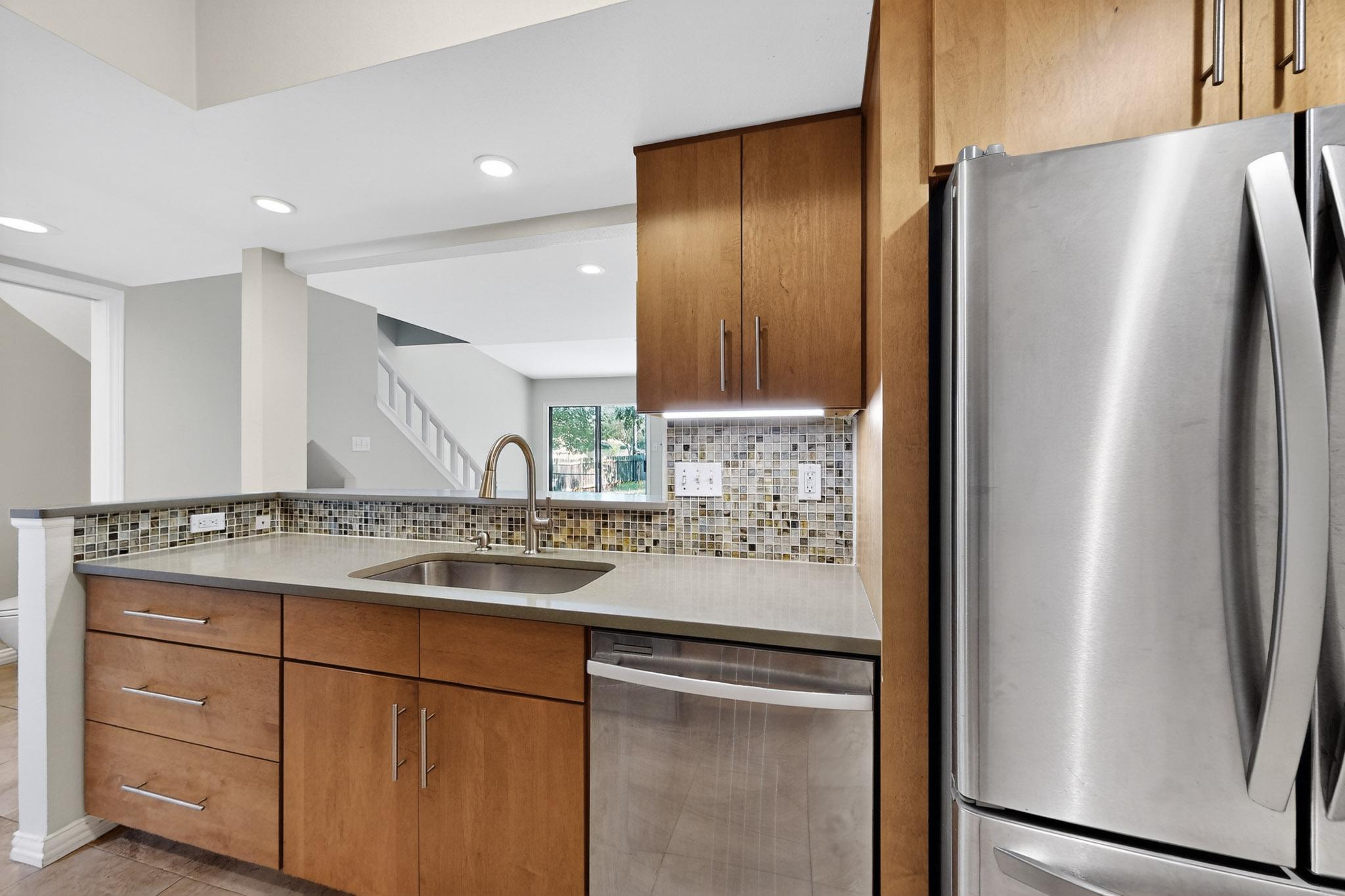 6023 Old Fredericksburg Road, Unit A Austin, TX 78749 - Photo 9 of 29 A well-appointed kitchen features custom cabinetry, stainless steel appliances, and elegant recessed lighting.
