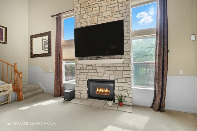 a living room with a fireplace and a flat screen tv