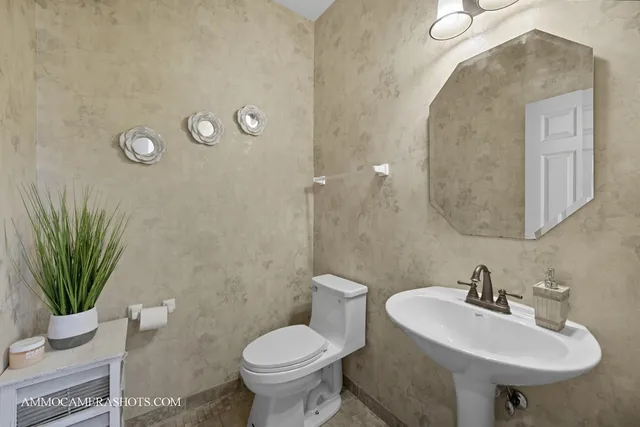 a bathroom with a sink toilet and a mirror