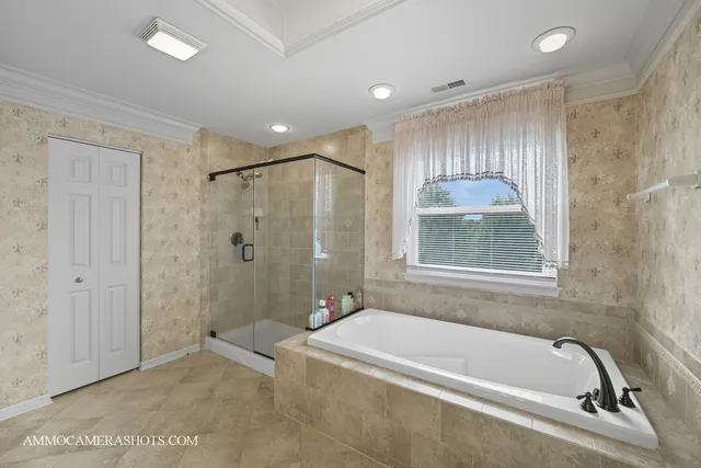 a bathroom with a tub a shower and a sink