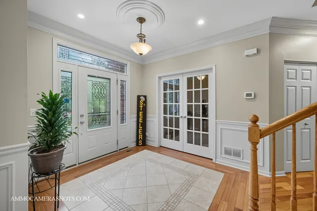 a view of an entryway with wooden floor and door