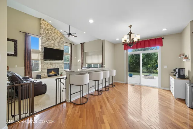 a view of a livingroom with furniture a flat screen tv and wooden floor