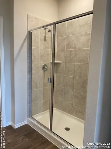 a bathroom with a glass shower door