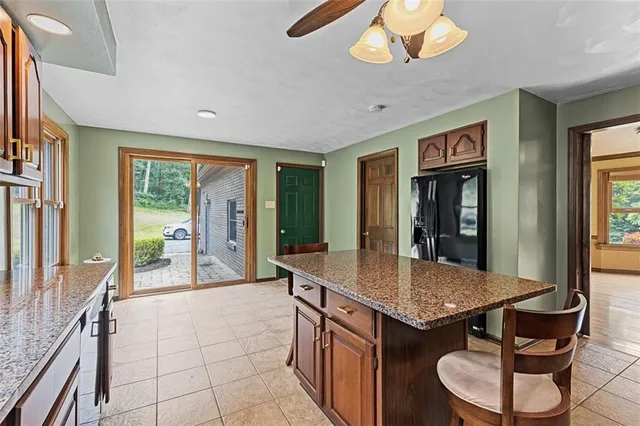 a kitchen with stainless steel appliances granite countertop a sink and a refrigerator