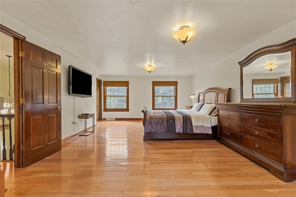 5150 Mamont Road Murrysville, PA 15668 - Photo 16 of 50 a bedroom with a bed and a dresser with wooden floor