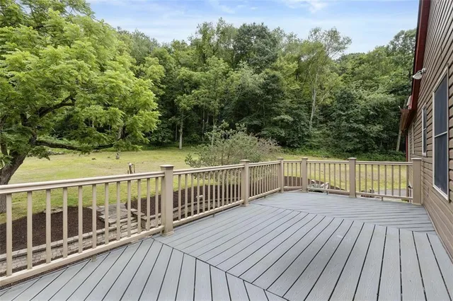 a view of deck with wooden floor and fence