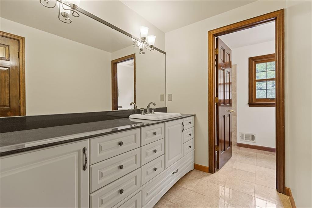 5150 Mamont Road Murrysville, PA 15668 - Photo 28 of 50 a bathroom with a granite countertop sink mirror and