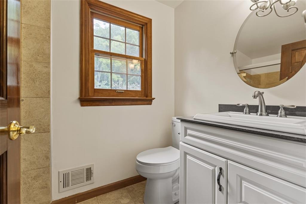 5150 Mamont Road Murrysville, PA 15668 - Photo 29 of 50 a bathroom with a toilet a sink and a mirror