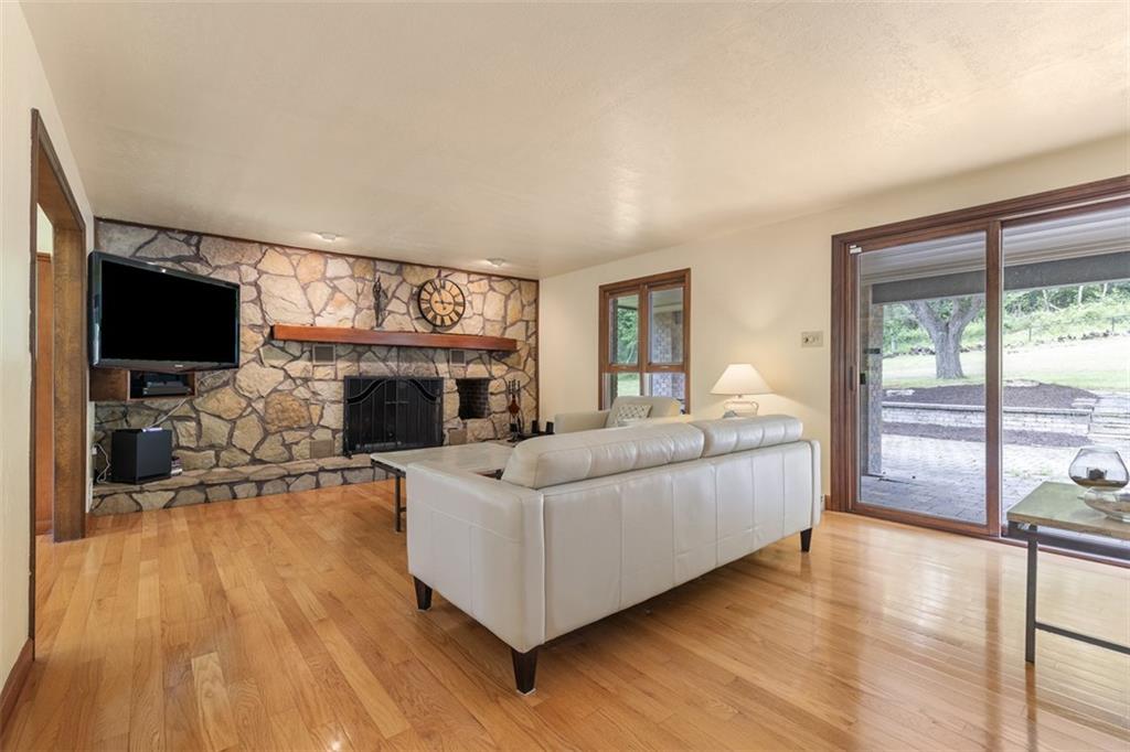 5150 Mamont Road Murrysville, PA 15668 - Photo 7 of 50 a living room with furniture a flat screen tv and a fireplace