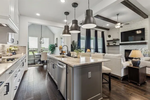a kitchen with stainless steel appliances granite countertop a sink and a stove