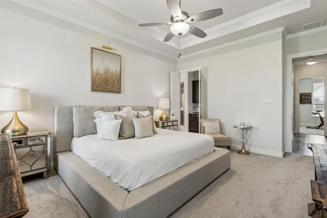 a bedroom with a large bed and a chandelier