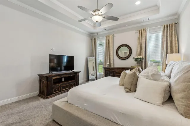 a bedroom with furniture and a flat screen tv