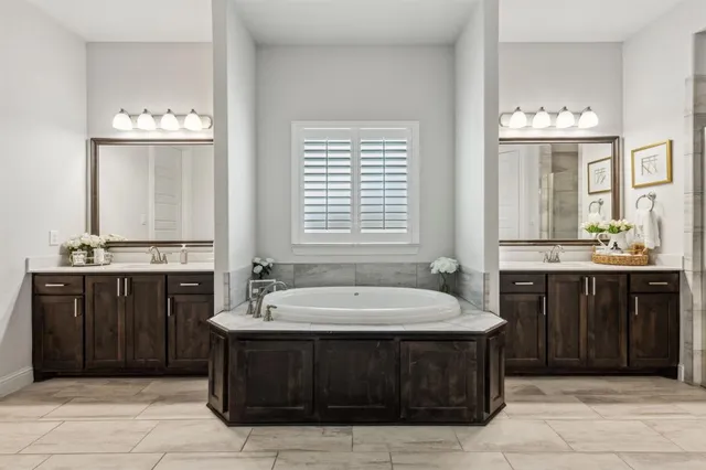 a bathroom with a sink vanity and a bathtub