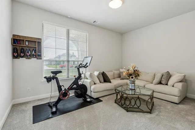 a living room with furniture a air conditioner and a window